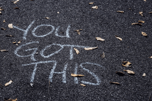 Chalk on the road that says "you got this"
